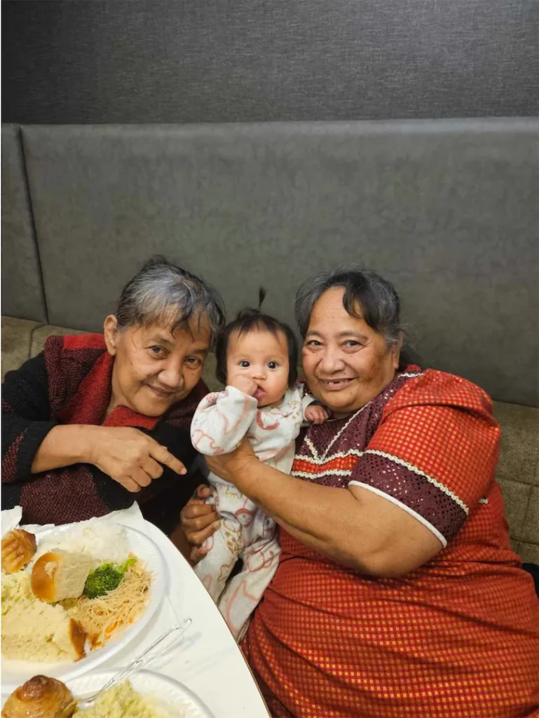 Marshallese women smiling with a child.