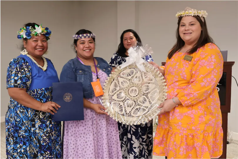 Marshallese women smiling while accepting a gift.