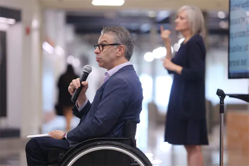 Man in wheelchair talking with microphone